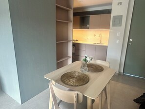 A compact kitchen with a built-in stove, a sink, and a small countertop.