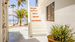 A white building with a sign reading "WELCOME to BABYLON BEACH RESORT SAN PEDRO". - Babylon Beach (San Pedro)