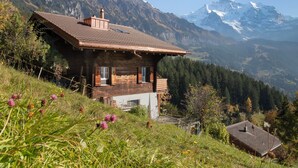 A wooden chalet with a sloped roof, set against a mountainous backdrop. - Jungfrau a d Ledi by Interhome (Wengen)