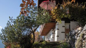 A building with a stone facade, wooden beams, and a red umbrella. - Jungfrau a d Ledi by Interhome (Wengen)