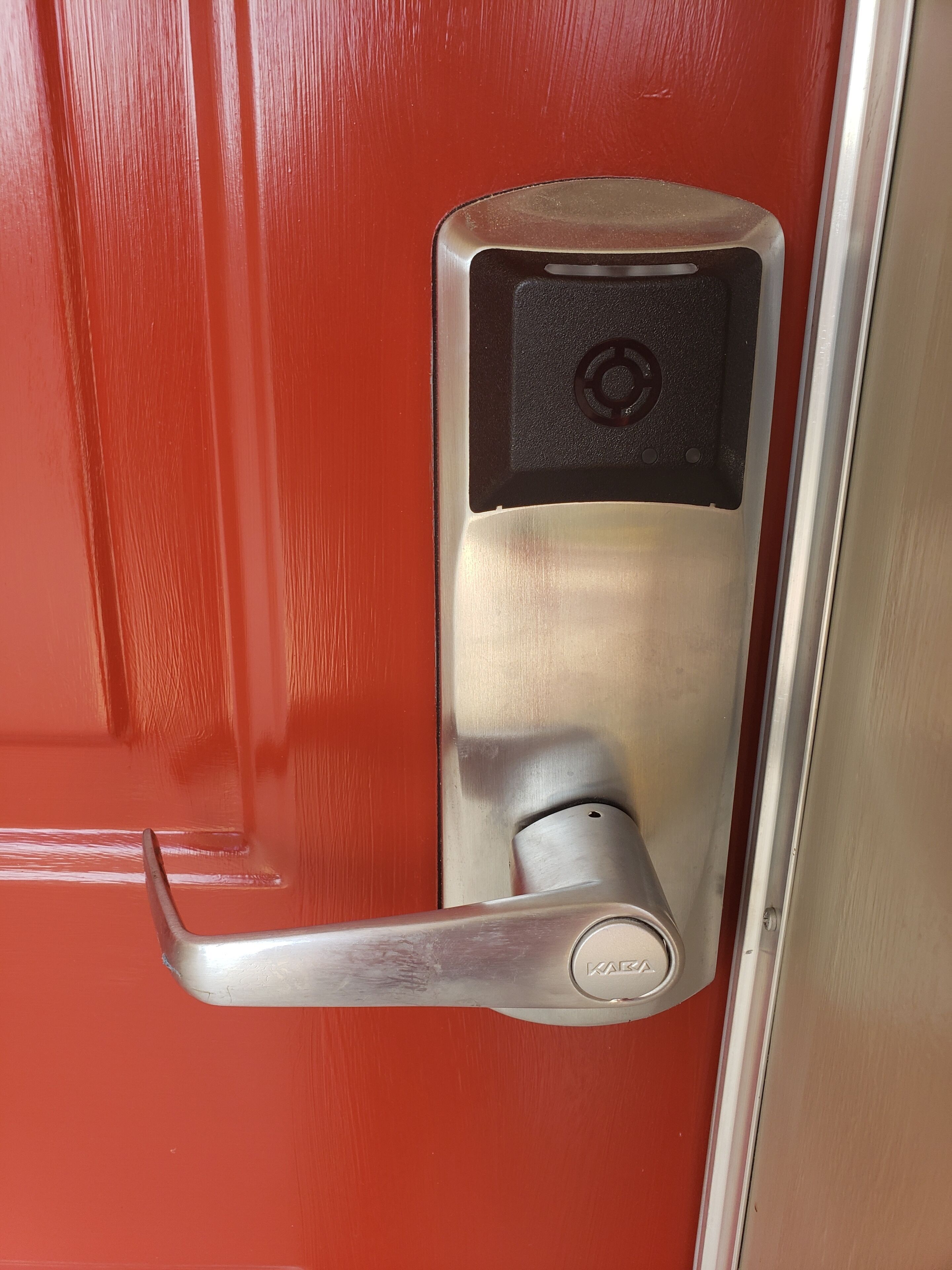 A modern door with a digital lock and a keyhole.