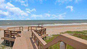 A wooden boardwalk leading to a beach with a clear view of the ocean. - Seas the Day - Serene condo w/ pool & beach access (Ponte Vedra Beach)