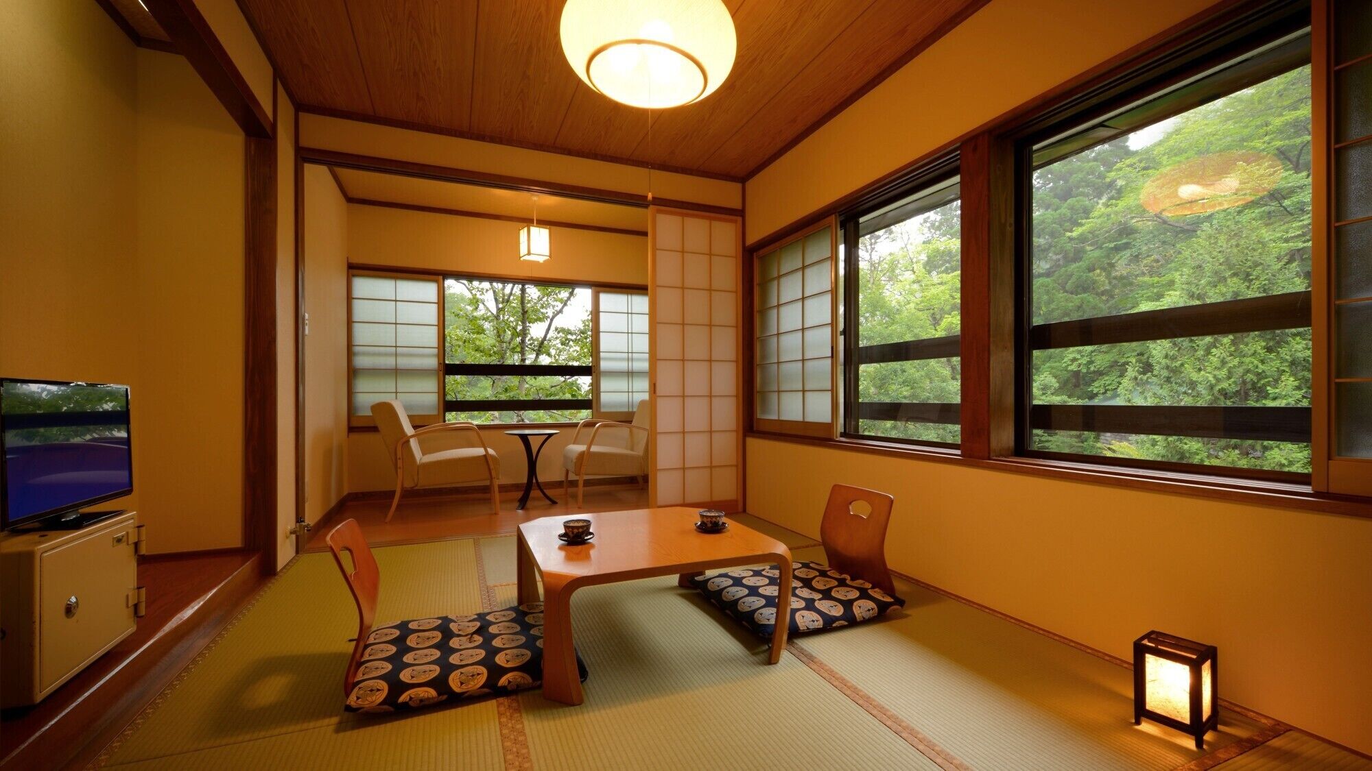 A traditional Japanese room with tatami flooring, a low table, and sliding shoji doors.