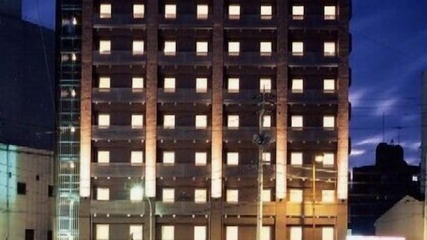 A multi-story hotel building with a sign reading 'HOTEL ABISSA' at the top.