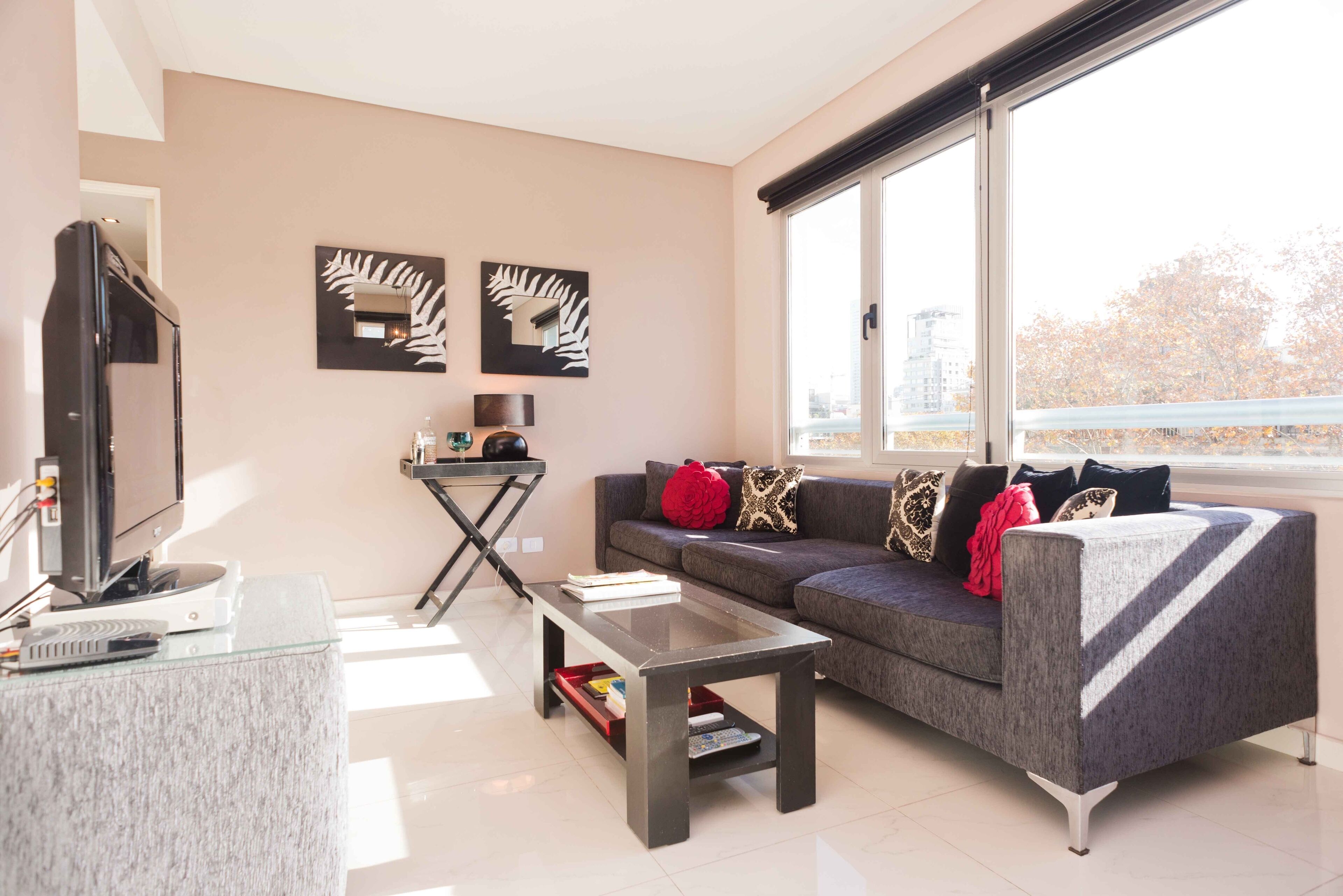 A modern living room with a sofa, coffee table, and a flat-screen TV.