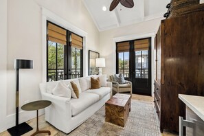 A modern living room with a white sofa, a wooden coffee table, and a floor lamp.