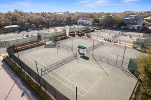 An outdoor tennis court with multiple courts, surrounded by trees and residential buildings. - Carriage House | 30 Sec Walk to Beach | Pool Access | Across Eastern Green (Rosemary Beach)