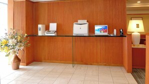 A reception desk with a computer, printer, and phone. - Okayama Green Hotel (Okayama)