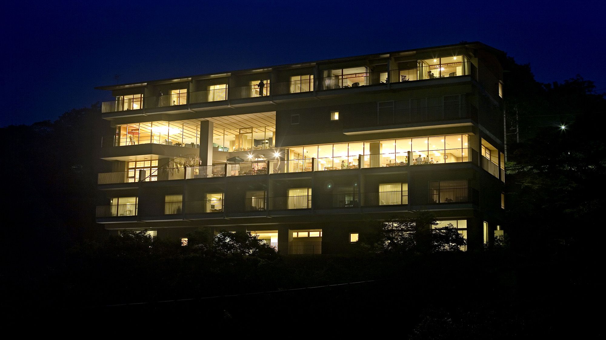A multi-story building with balconies and large windows, likely a hotel or apartment complex.