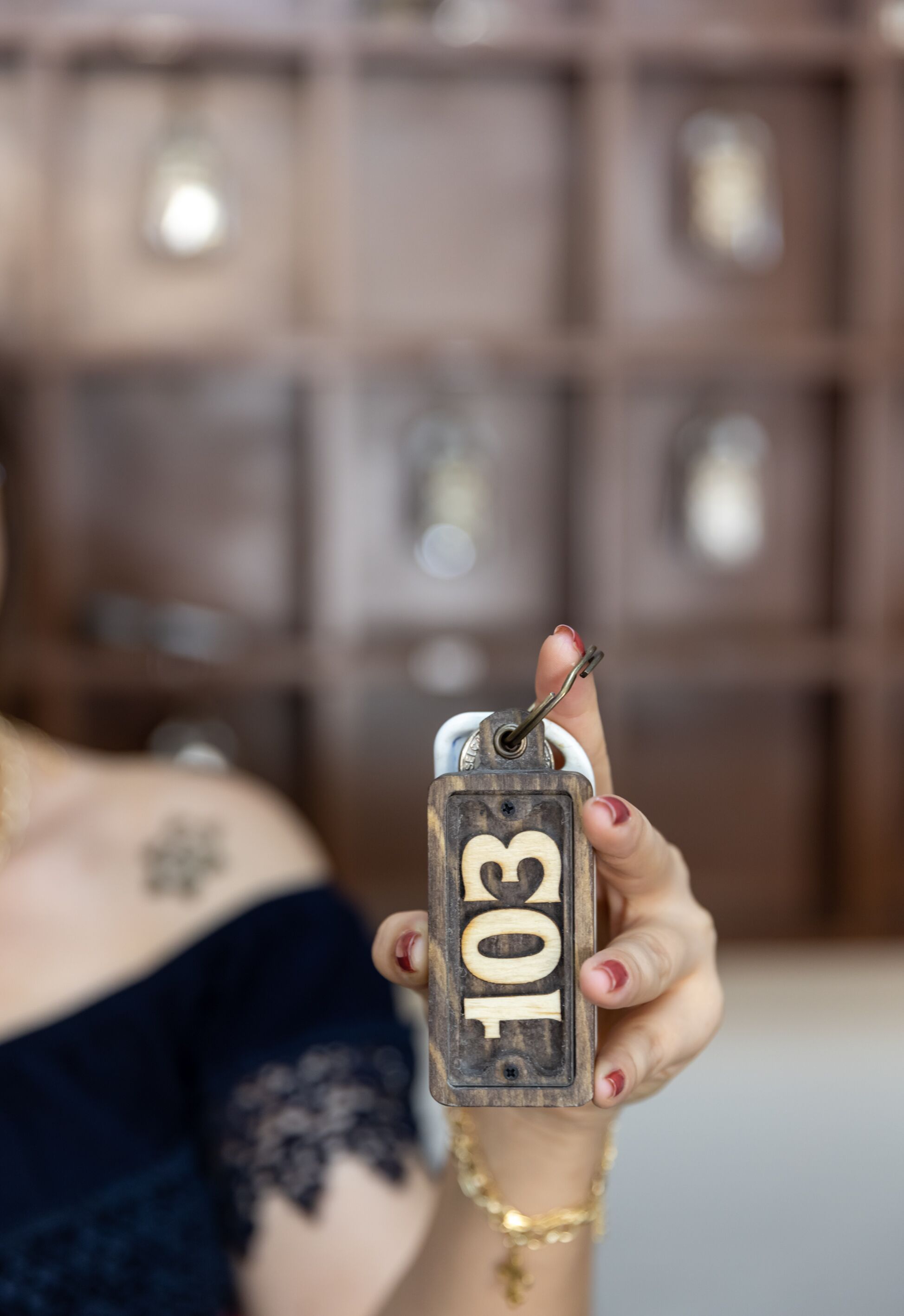 A person holding a key with the number 103.