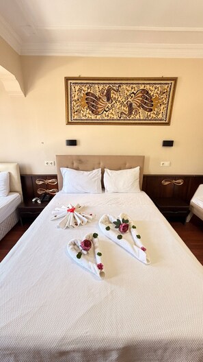 A hotel room with a neatly made bed, a decorative wall hanging, and a classic headboard. - Ephesus Centrum (Selçuk)