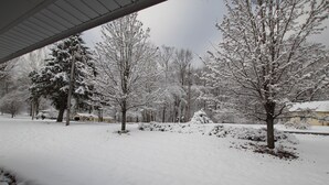 A snow-covered residential area with trees and houses. - Comfortable lake living, pool access, 3 miles to marina (Monticello)