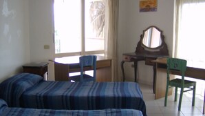 A room with two beds, a desk, a chair, and a window. - In the greenery of Fisciano large apartment in villa (FISCIANO)