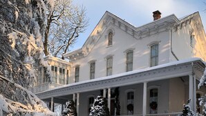 A large, white, two-story building with a covered porch and multiple windows. - Susquehanna Manor Inn (Marietta)