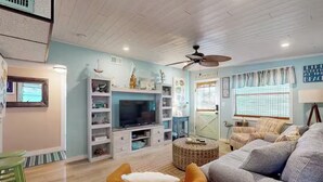 A living room with a television, sofa, and a ceiling fan. - Piece of Paradise for All Seasons!!! Bring Your Boat! (St James City)
