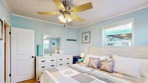 A bedroom with a bed, a ceiling fan, a dresser, a nightstand, and a window with blinds. - Piece of Paradise for All Seasons!!! Bring Your Boat! (St James City)