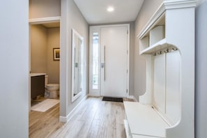 Enter a bathroom with a toilet and sink, featuring a window above the toilet.