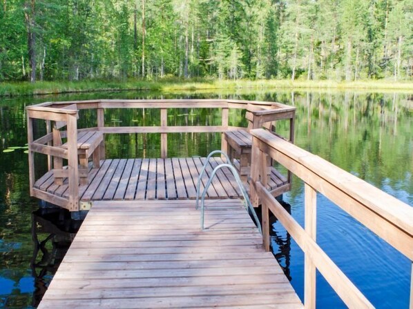 Guests can access the serene waters from this simple dock, surrounded by lush greenery.