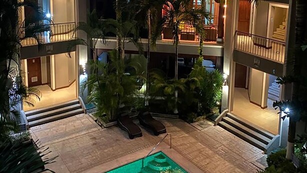 A rooftop pool area with lounge chairs and a staircase leading to the upper floors. - Macaw #18 - Beach access penthouse - safe location, surfing, walking trails (Jaco)