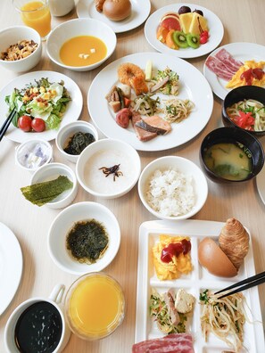 A variety of dishes including rice, soup, and seafood, arranged on a wooden table. - Hotel Lantana Naha Kokusai - Dori (Naha)
