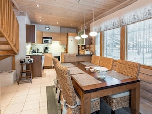 A modern kitchen with wooden cabinets, a microwave, and a refrigerator.