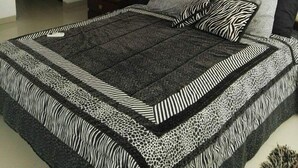 A bedroom with a bed, a nightstand, a lamp, and a wardrobe. - Santa Cruz Furnished Department (Santa Cruz)
