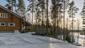 A wooden cabin with a covered porch and a snow-covered yard. - Tainan tupa by Interhome (Sysmä)