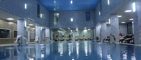 Indoor pool, pool umbrellas, pool loungers