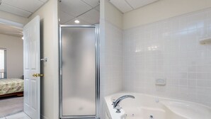 A bathroom with a shower enclosure, a bathtub, and a toilet. - Beautiful 3 bedroom condo, mid town, ocean block (Ocean City)