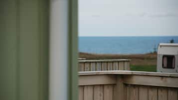 A wooden fence with a view of the ocean.