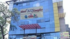 A hotel with a large sign advertising 'Hotel YKC'. - Iroomz VKG Complex (Bijapur)
