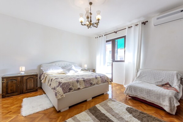 A bedroom with a bed, bedside table, lamp, and a chair. - Perfectly located holiday home with a private pool (Stanici, Omiš)