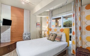 A hotel room with a large bed, a desk with a flat-screen TV, a fan, and a window with curtains. - Gulf Front - Grayton Beach - Next to Red Bar! (Santa Rosa Beach)