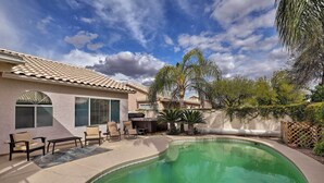 A backyard with a swimming pool, patio furniture, and a house with a tiled roof. - Tucson Getaway w/ Yard, Pool, Hot Tub + Gas Grill! (Tucson)