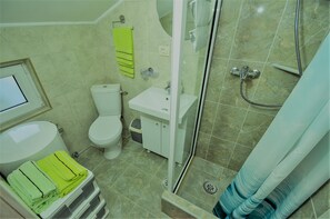 Shower, hair dryer, towels, toilet paper
