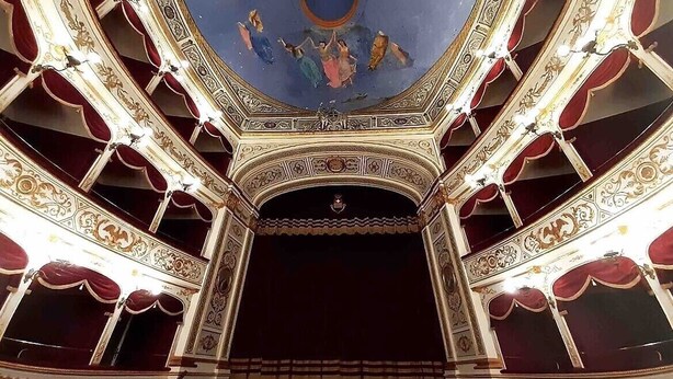 An ornate theater interior with a central stage, multiple balconies, and intricate ceiling artwork. - Nonna Ninetta "typical Sicilian house" (Avola)