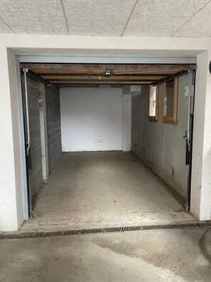 A narrow, enclosed space with a concrete floor and a metal door frame. - Faronniere 5 : Duplex 3 bedrooms in village heart (MORZINE)
