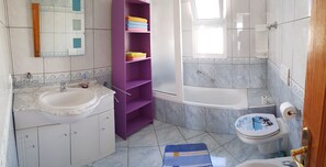 Bathtub, hair dryer, bidet, towels