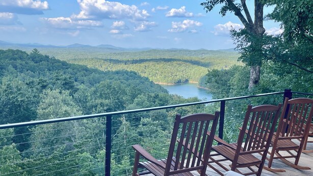 A deck with wooden chairs and a fire pit overlooking a forested valley and lake. - LAKE BLUE RIDGE VIEW & ACCESS, POOL TBL, PROJECTOR, FIRE PIT, HOT TUB, DOGS OKAY (Blue Ridge)