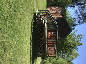 Enjoy panoramic views from this elevated lookout point surrounded by a lush green area.