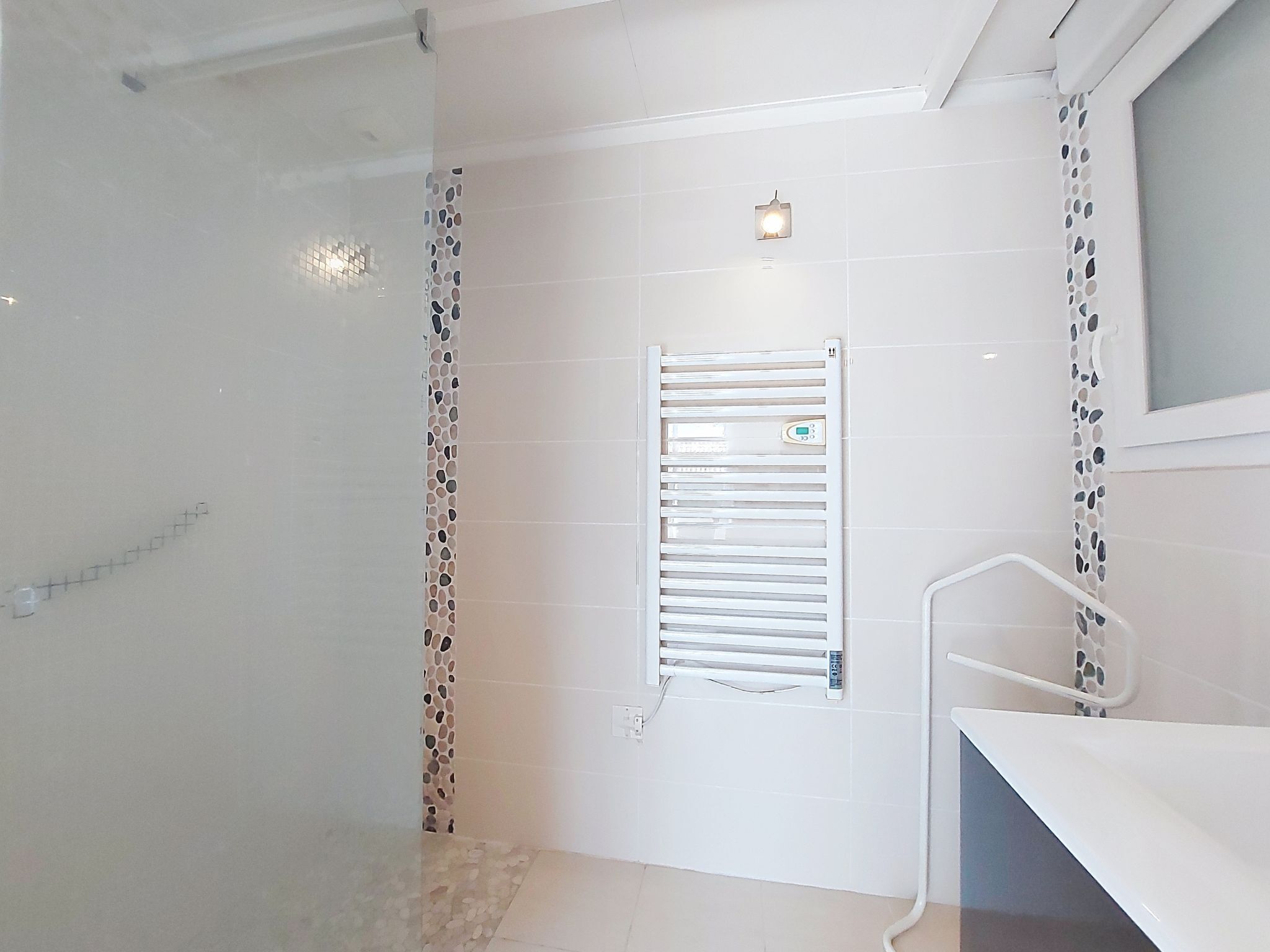 A bathroom with a shower, a toilet, and a sink.