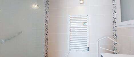 A bathroom with a shower, a toilet, and a sink.