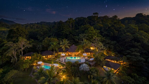 A resort with multiple buildings, a swimming pool, and lush greenery. - The Tranquilo Lodge (Drake Bay)