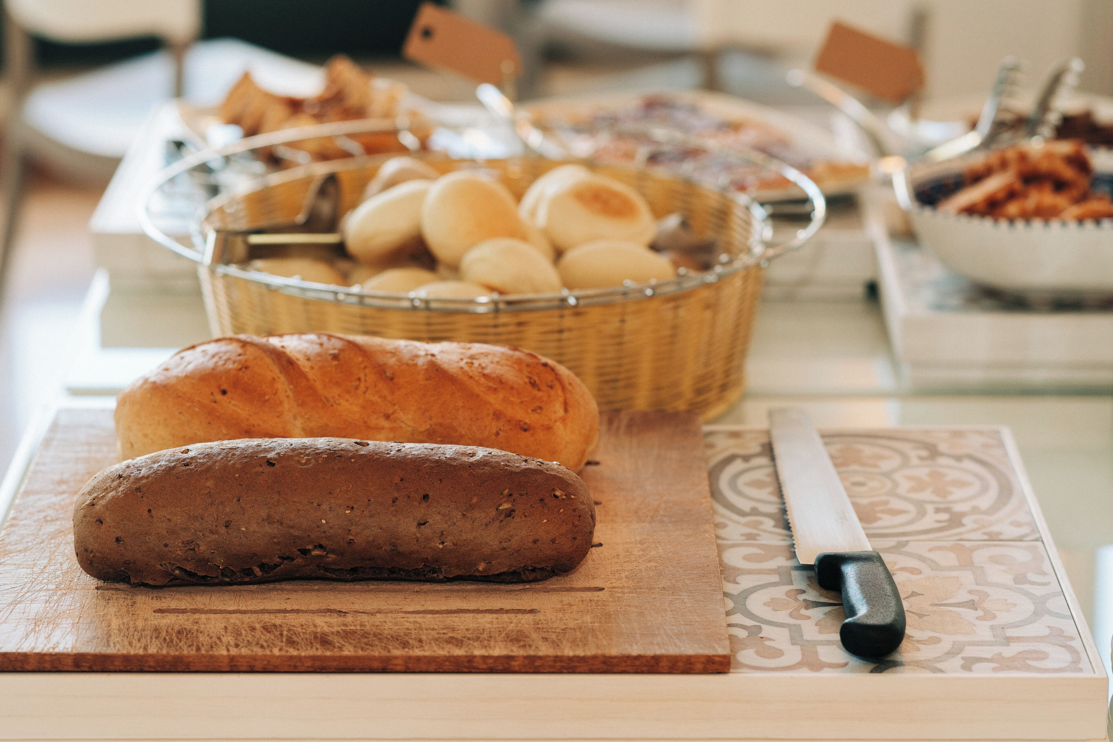 Een brood op een snijplank met een mes ernaast.