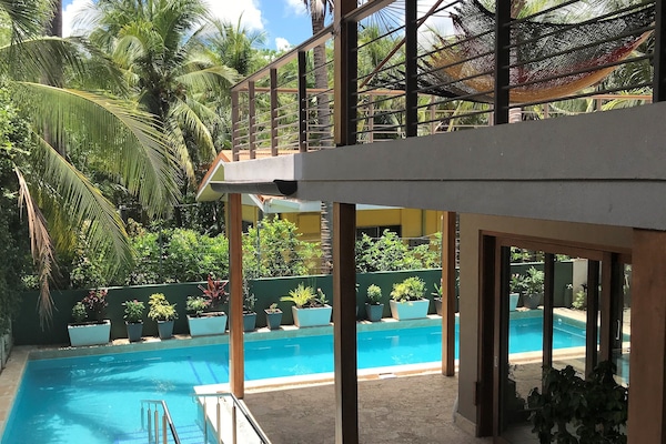 Outdoor pool, pool loungers, lifeguards on site