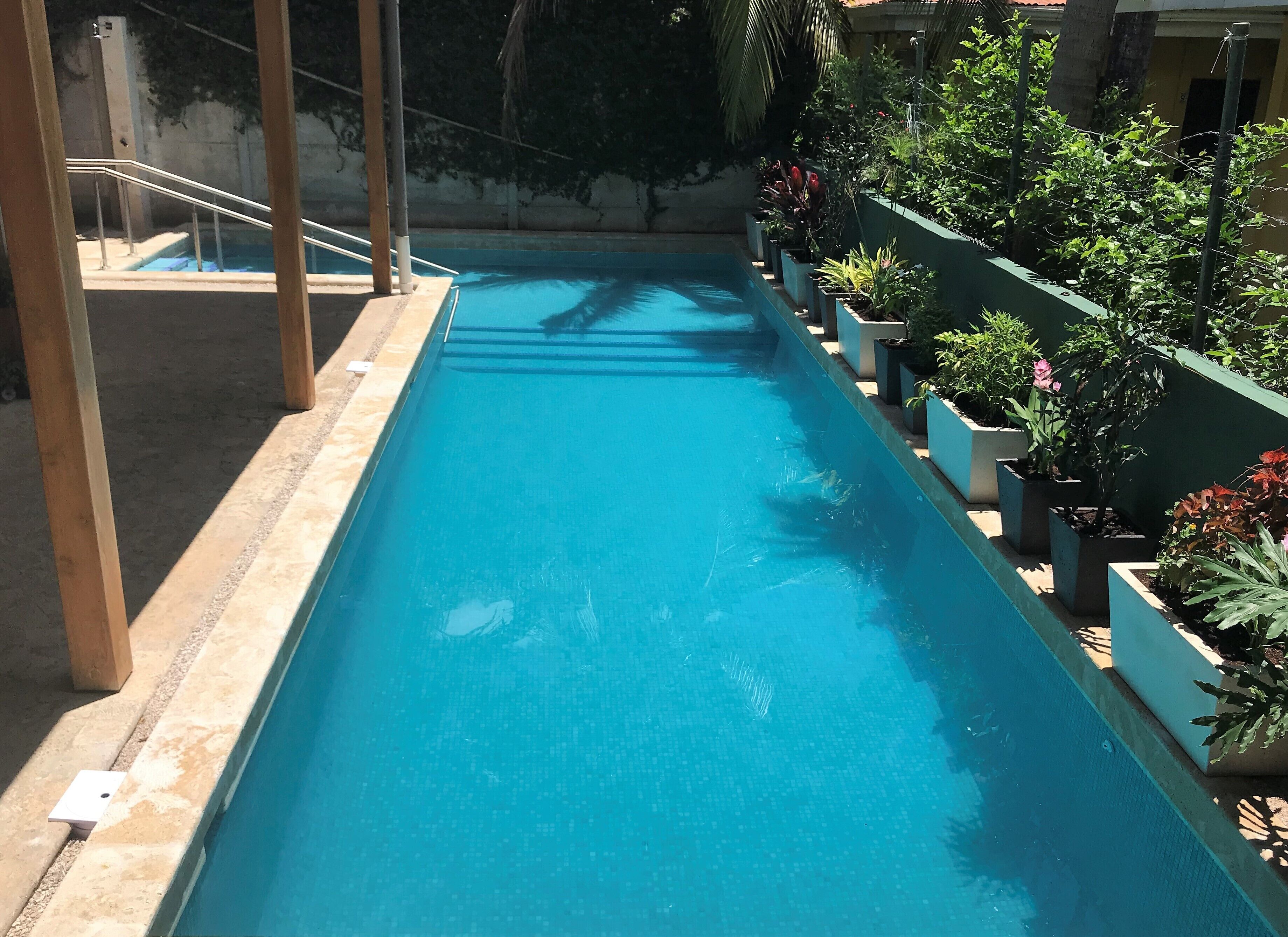 Outdoor pool, pool loungers, lifeguards on site