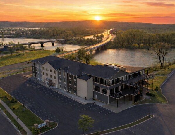 A multi-story building with a parking lot in front. - Waterfront Hotel (Prairie Du Chien)