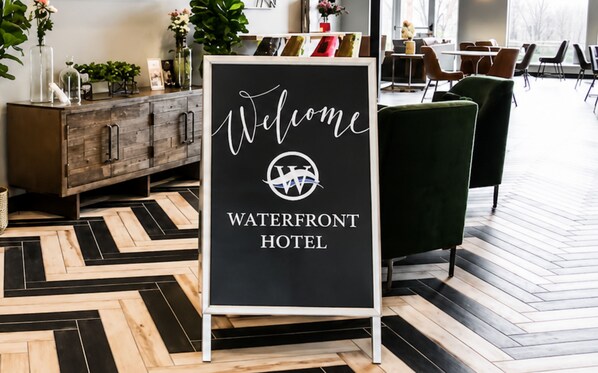 A welcome sign at the Waterfront Hotel with a modern interior design.