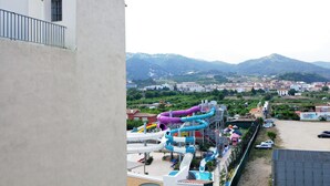 A water park with multiple water slides and a parking area.