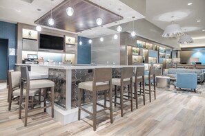 A modern kitchen with a central island, bar stools, and pendant lighting. - Fairfield Inn & Suites by Marriott San Jose North/Silicon Valley (San Jose)
